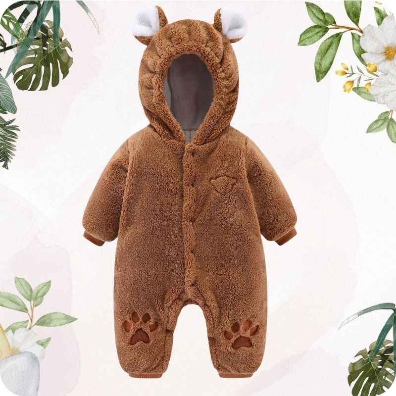 Brown baby snowsuit with bear ears and paw prints on a light pink background with green leaves.