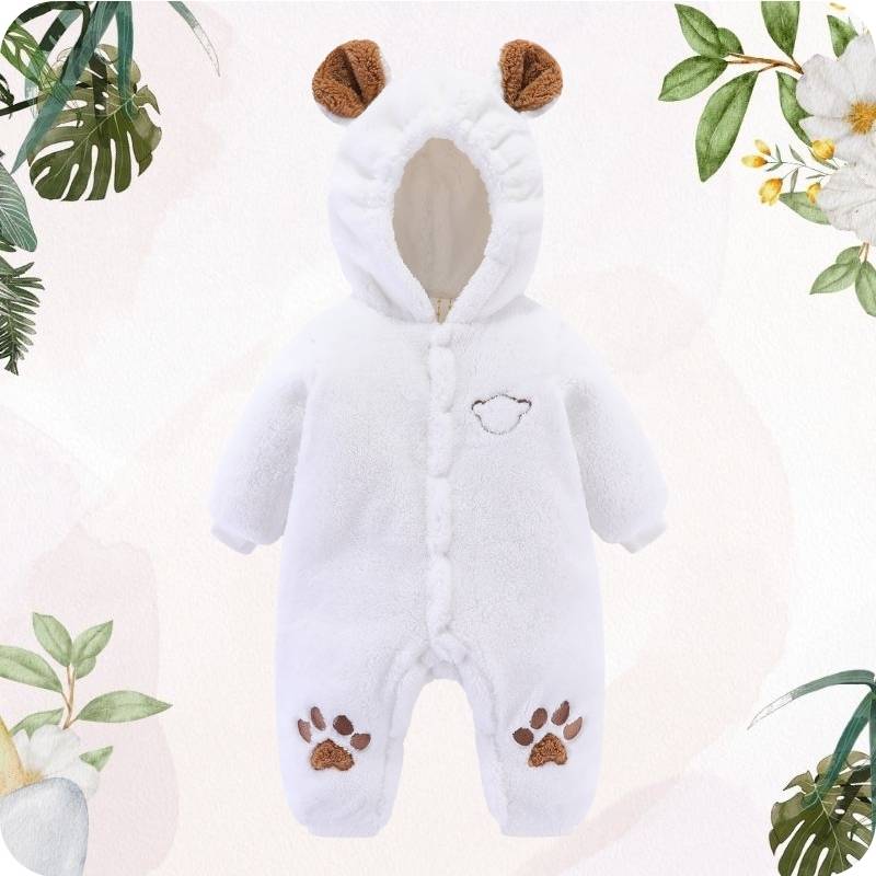 White baby onesie with brown accents on a light pink background with greenery