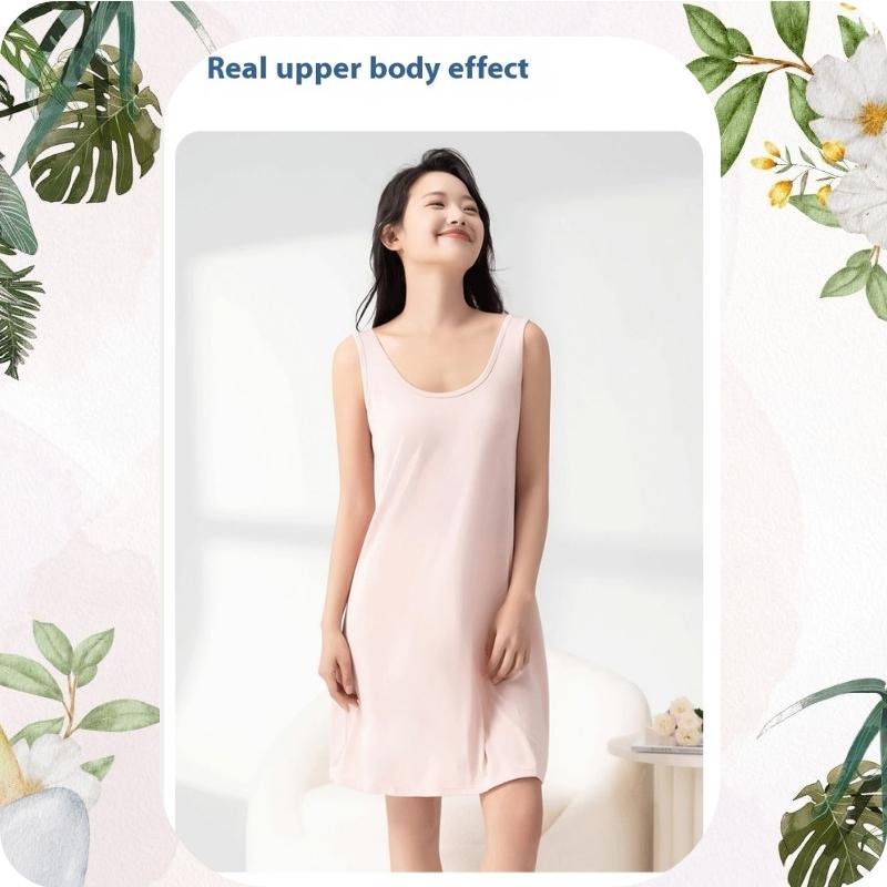 Woman wearing a pink slip dress with decorative elements on a light background