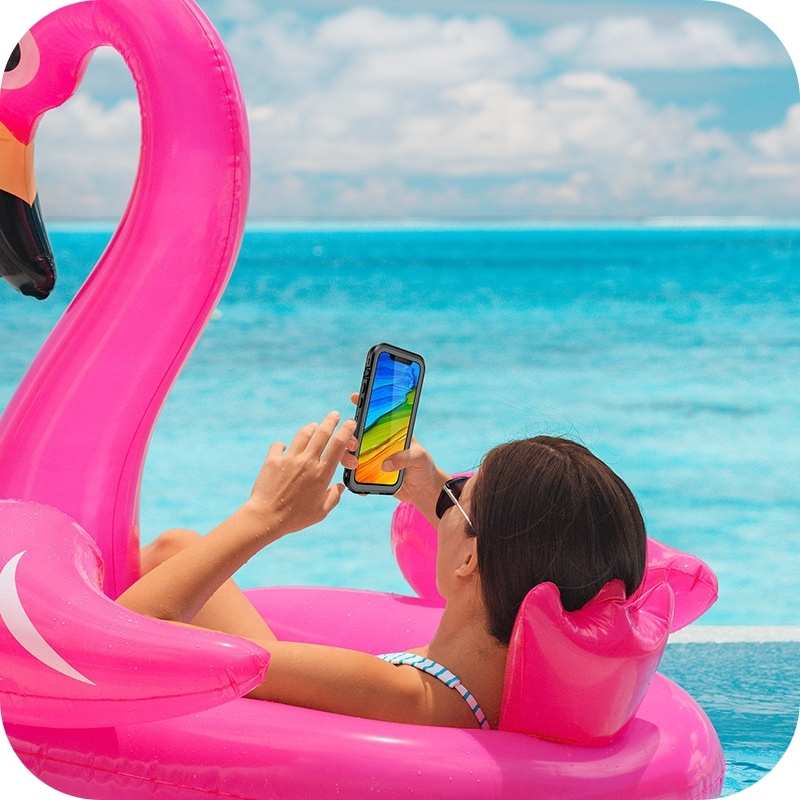 Lady lying on a blowup bird holding the waterproof iPhone case—durable, shockproof, and designed for swimming, diving, and showering
