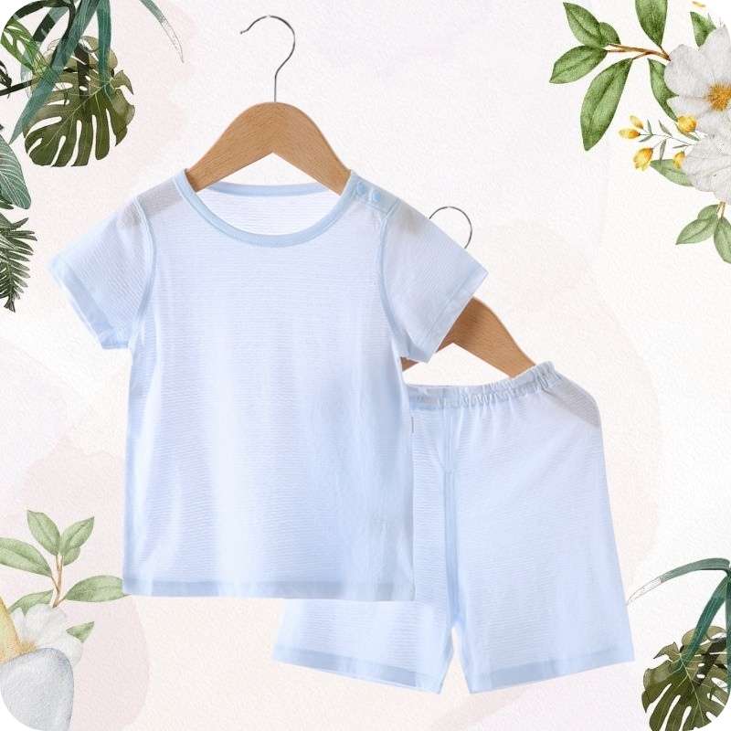 Light blue children's t-shirt and shorts set on a hanger with a floral and leafy background.