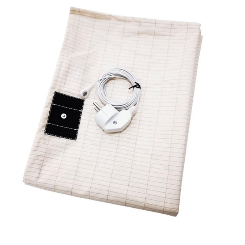 Close-up of a textured mat with a connected cable, highlighting surface details and material composition for functionality and durability.