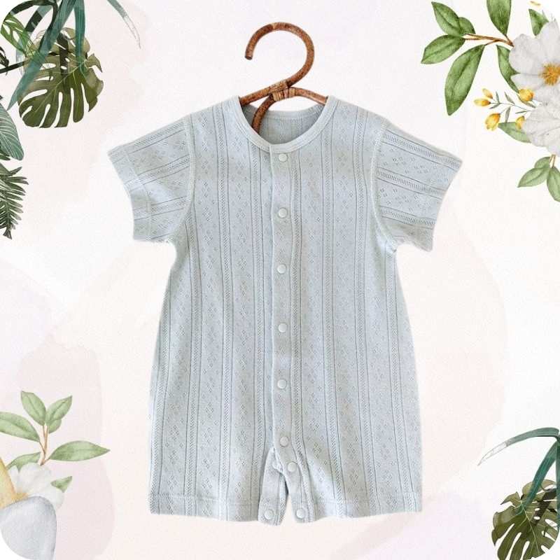 Light blue baby romper on a hanger with floral and plant decorations