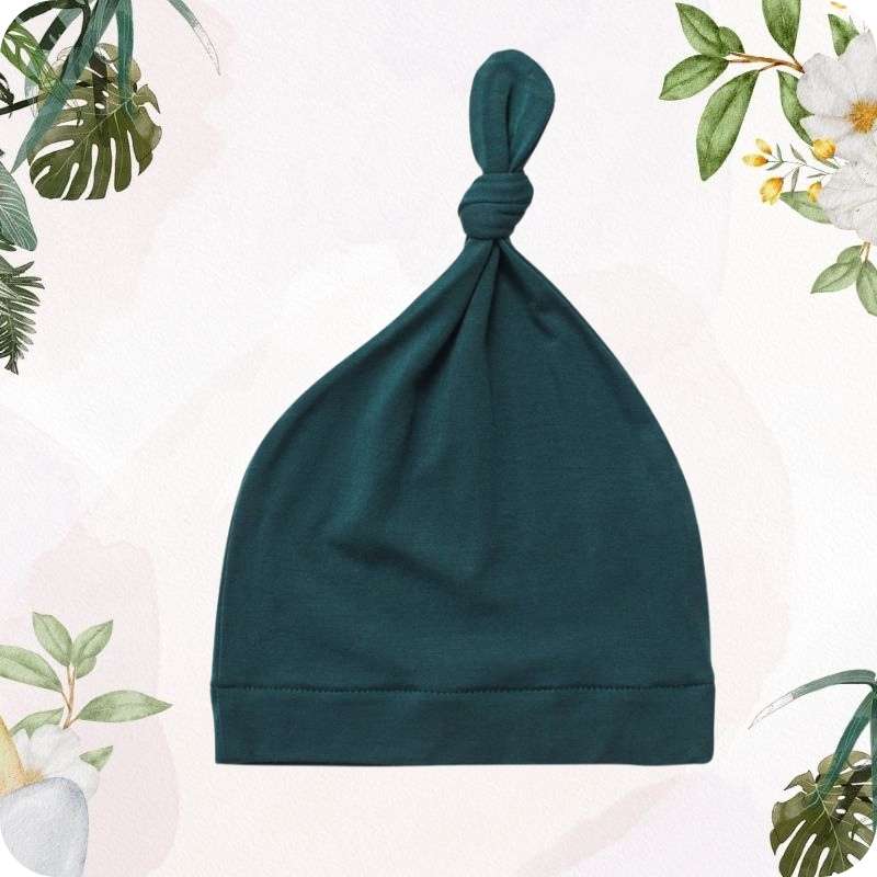 Black baby hat on a white background with floral decorations