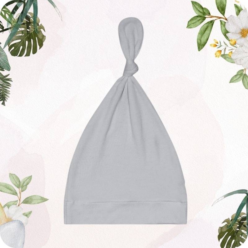 Gray baby hat on a white background with floral and plant decorations