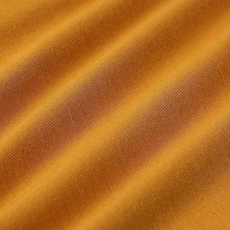 Close-up of textured mustard yellow fabric