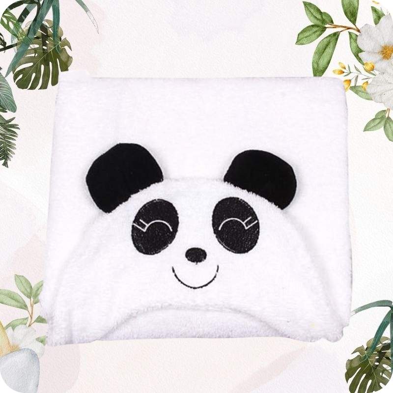 White towel with panda face design on a white background with green leaves and flowers.