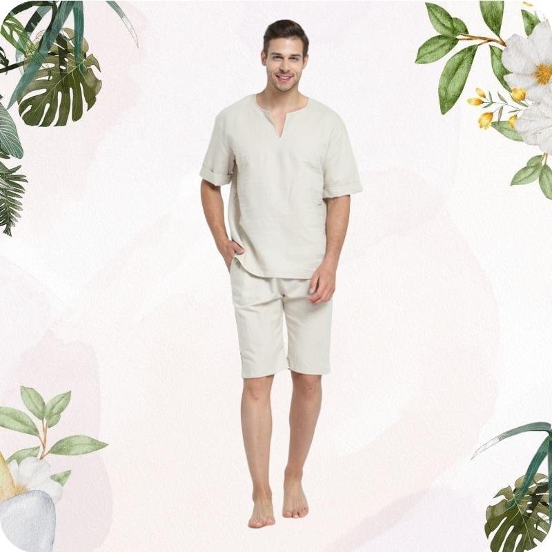 Man wearing a beige colored outfit with floral and leaf decorations on a white background