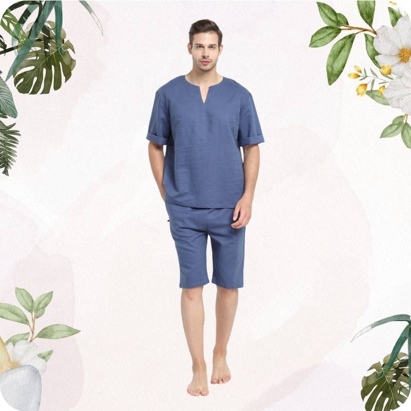 Man wearing a blue pajama set on a white background with floral and plant decorations.