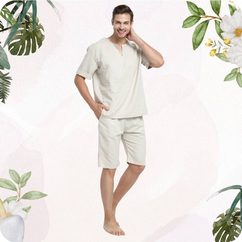 Man wearing a beige outfit with floral and leaf decorations on a white background