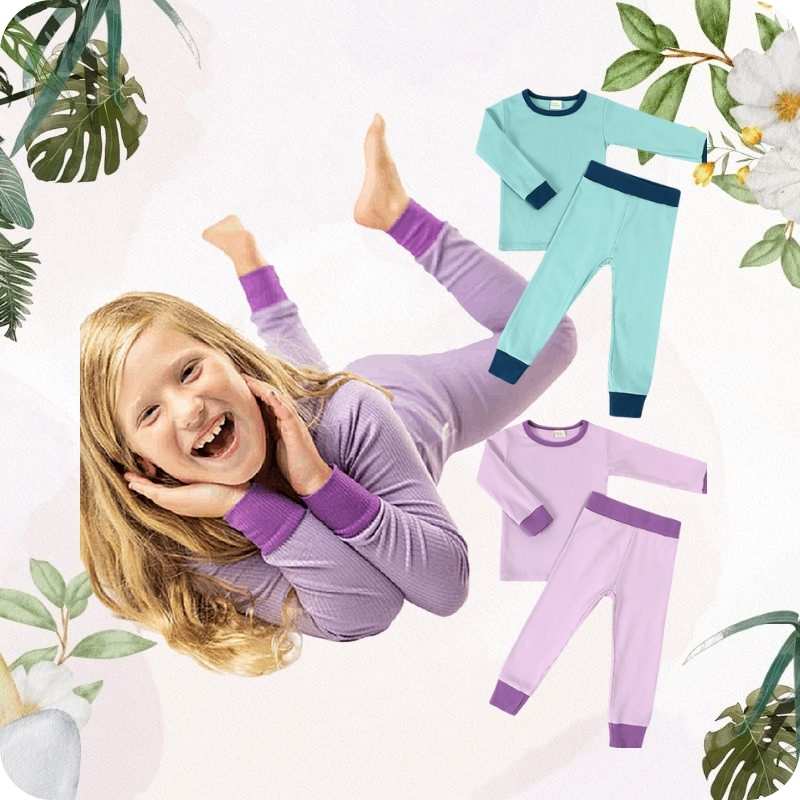 Child wearing purple pajamas with two additional pajama sets displayed on a white background with greenery.