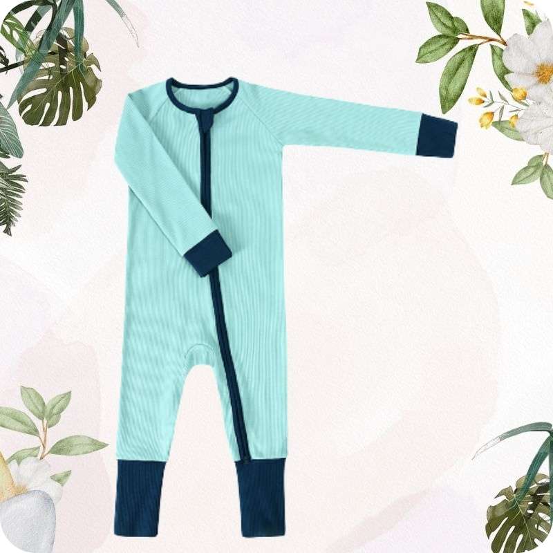 Light blue baby onesie with dark blue accents on a light pink background with floral and leaf decorations.