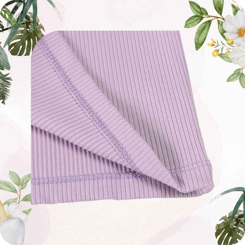 Stitching of pajamas with green leaves and white flowers in the background