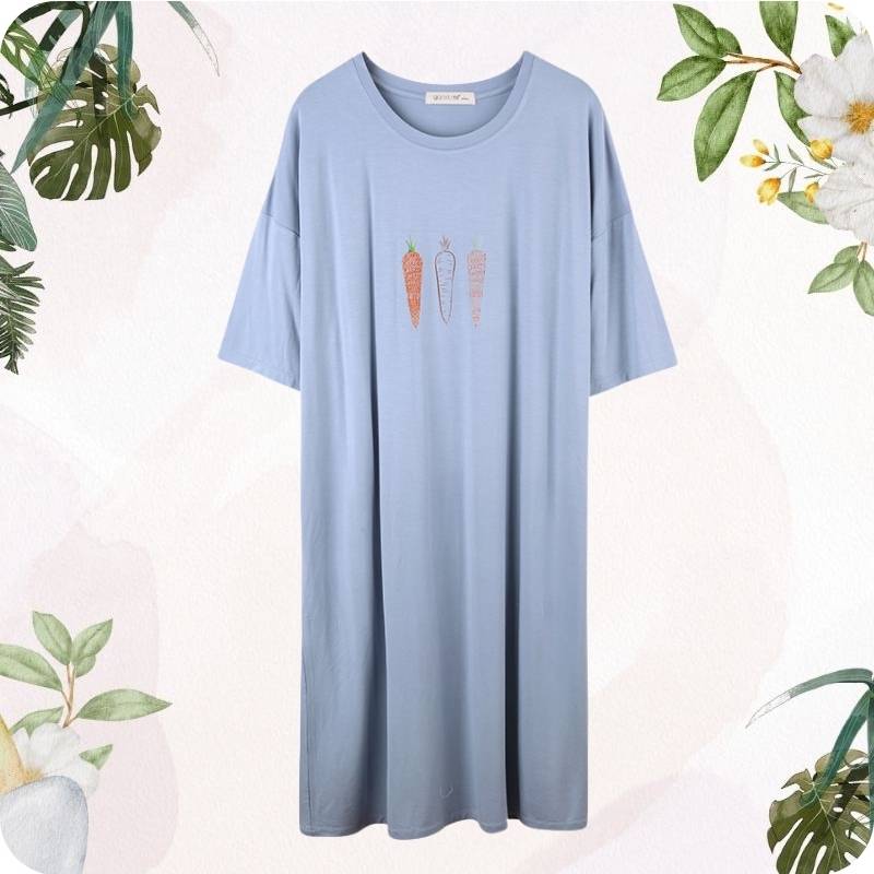 Light blue t-shirt with carrot illustrations on a white background with green leafy elements.