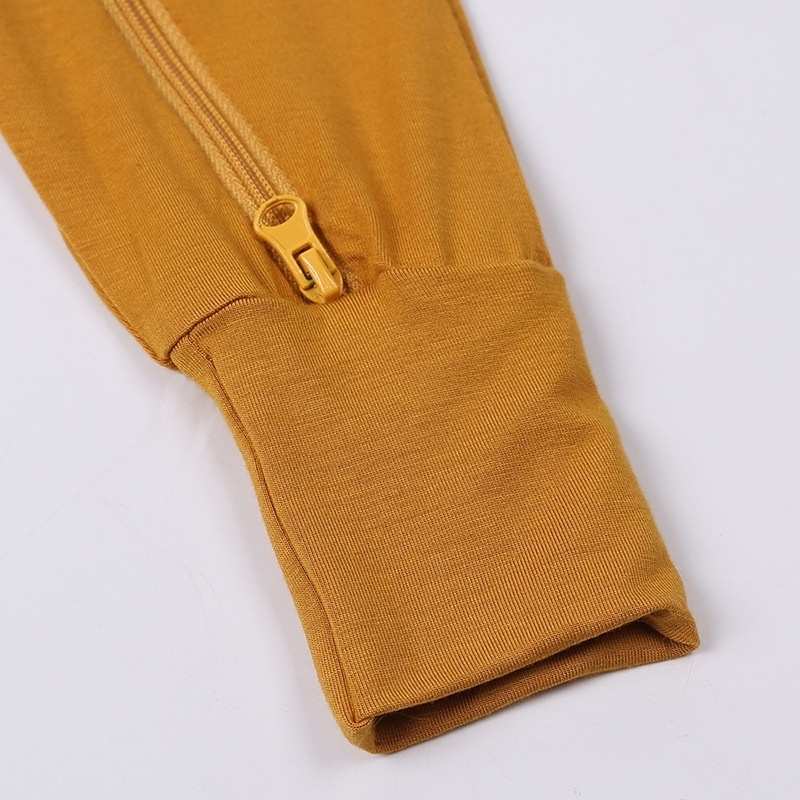 Mustard yellow fabric with a gold zipper on a white background