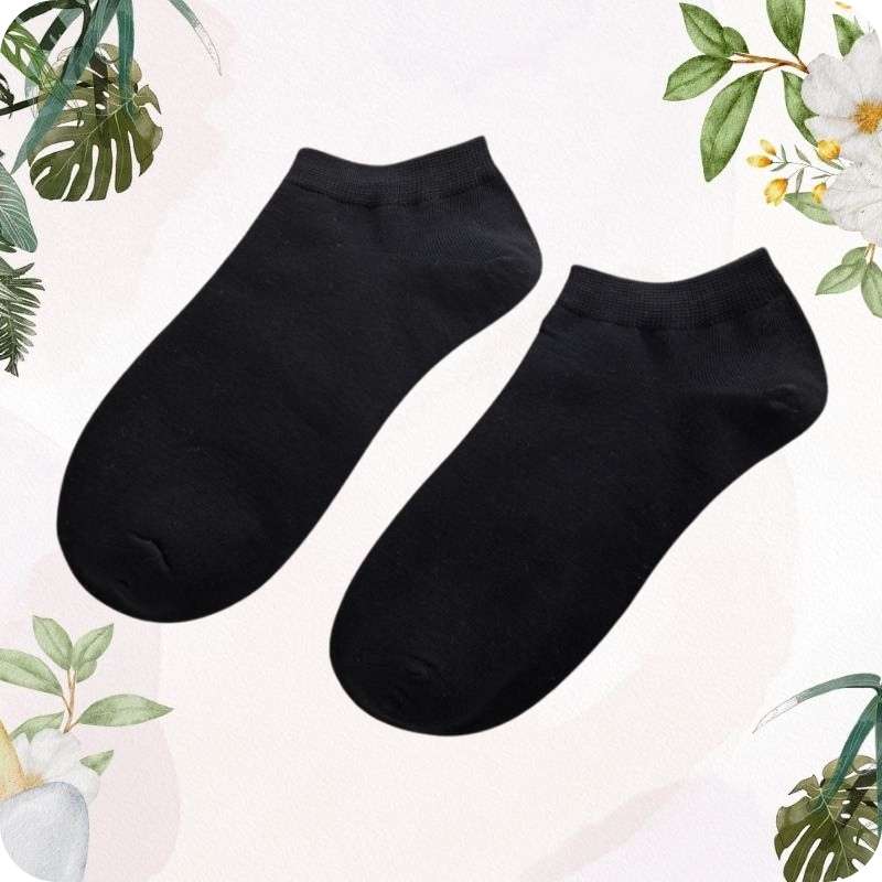 Two black ankle socks on a light background with floral and leaf decorations.