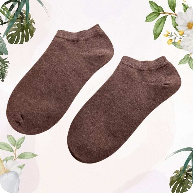 Pair of dark brown ankle socks on a light background with floral and leaf decorations.