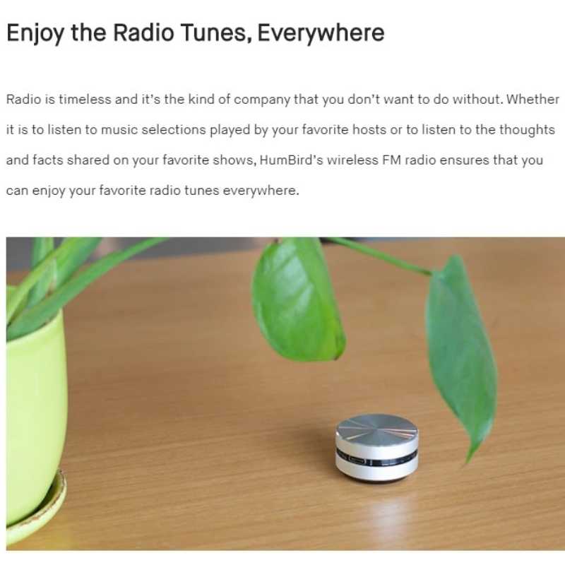 Speaker placed on a table next to a plant—compact, wireless, and designed for immersive audio experience