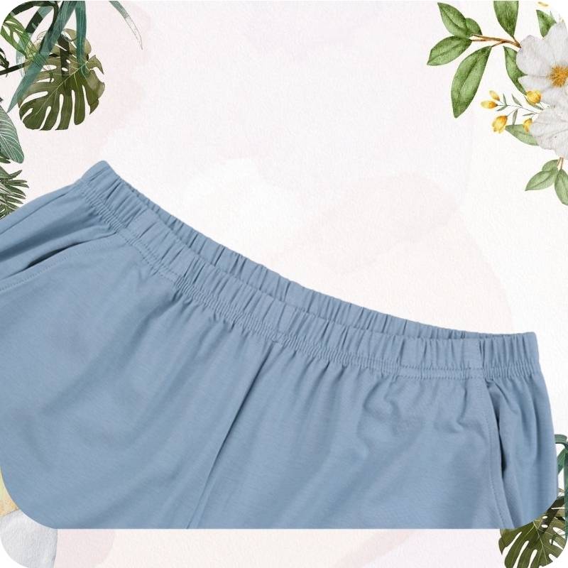 Light blue shorts on a white background with floral and leaf decorations